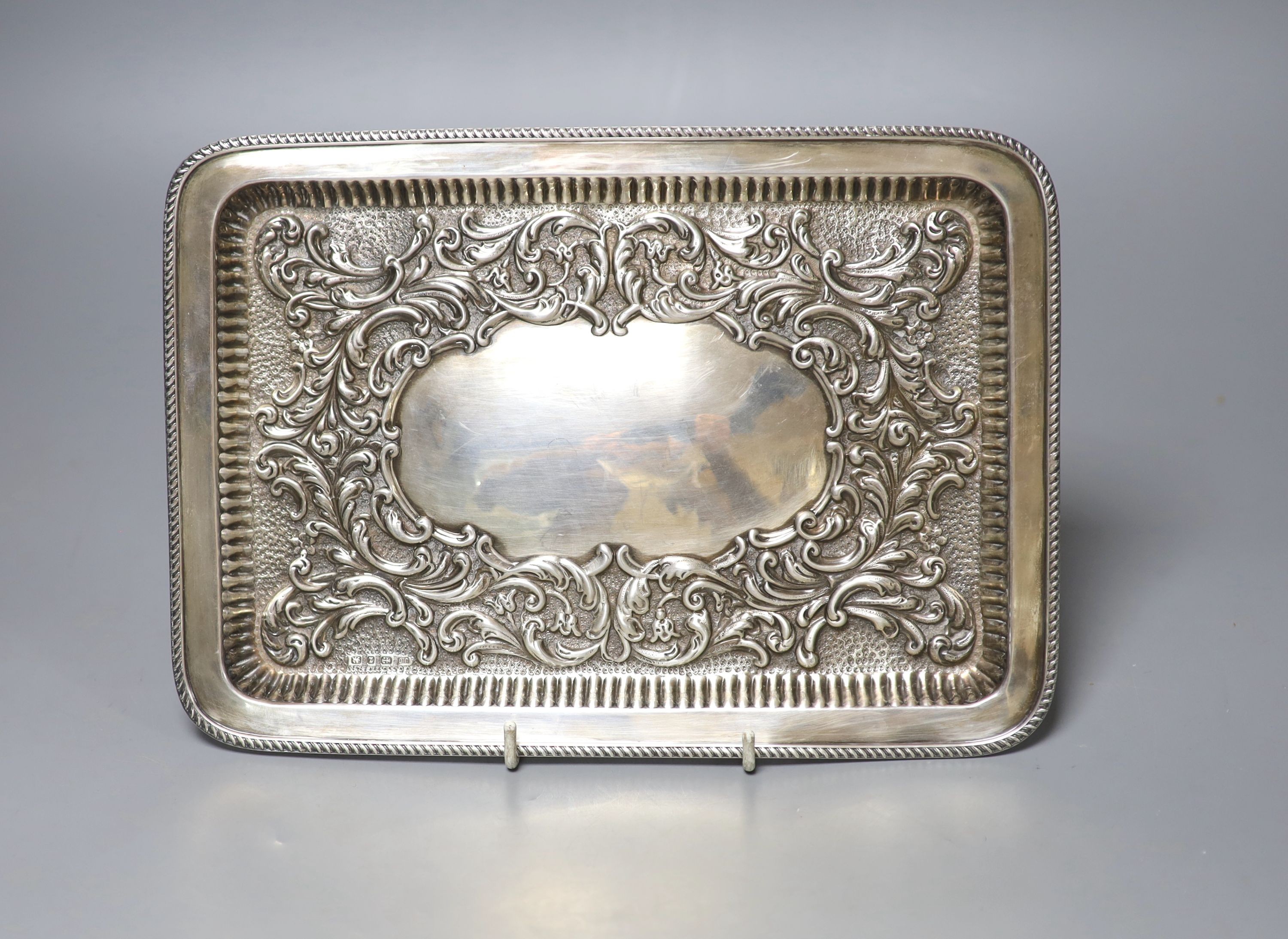 A late Victorian repousse silver rectangular dressing table tray, Joseph Gloster, Birmingham, 1899, 27.2cm, 10oz.